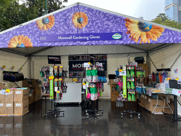 Morewell Gardening Gloves booth at Melbourne International Flower and Garden Show 2024 with colorful gloves displays under a sunflower-themed tent